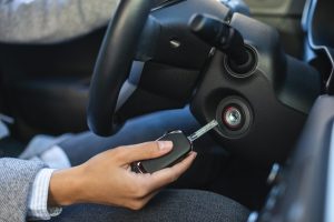 side-view-businesswoman-using-keys-turn-car (1)